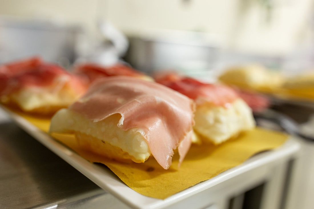 Fried dough with a platter of local cured meats, simple but irresistible