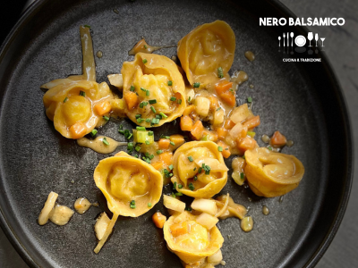 Shrimp tortelli, candied lemon, seasonal vegetables, and shellfish bisque
